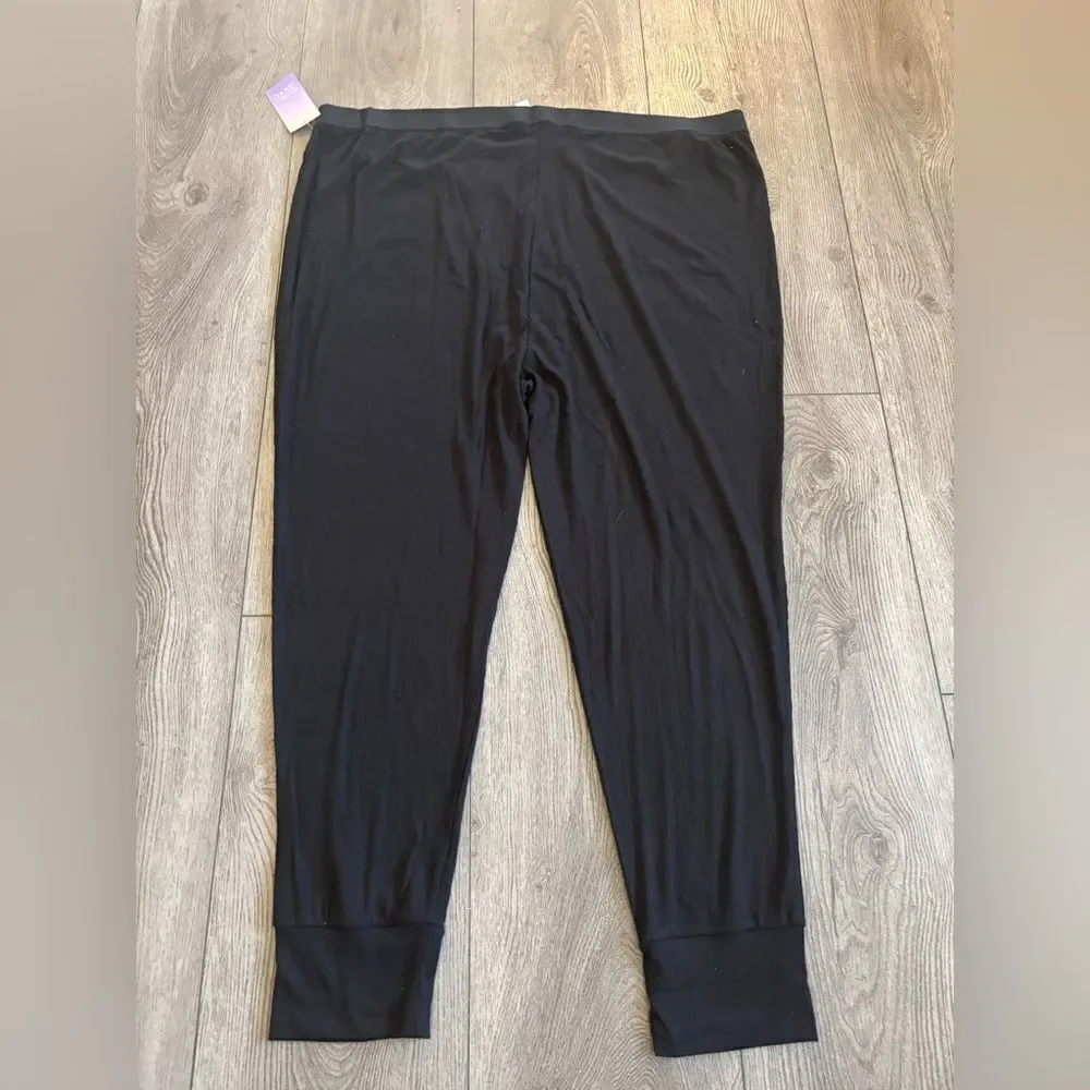 Stars above woman’s ribbed  knit pajama pants